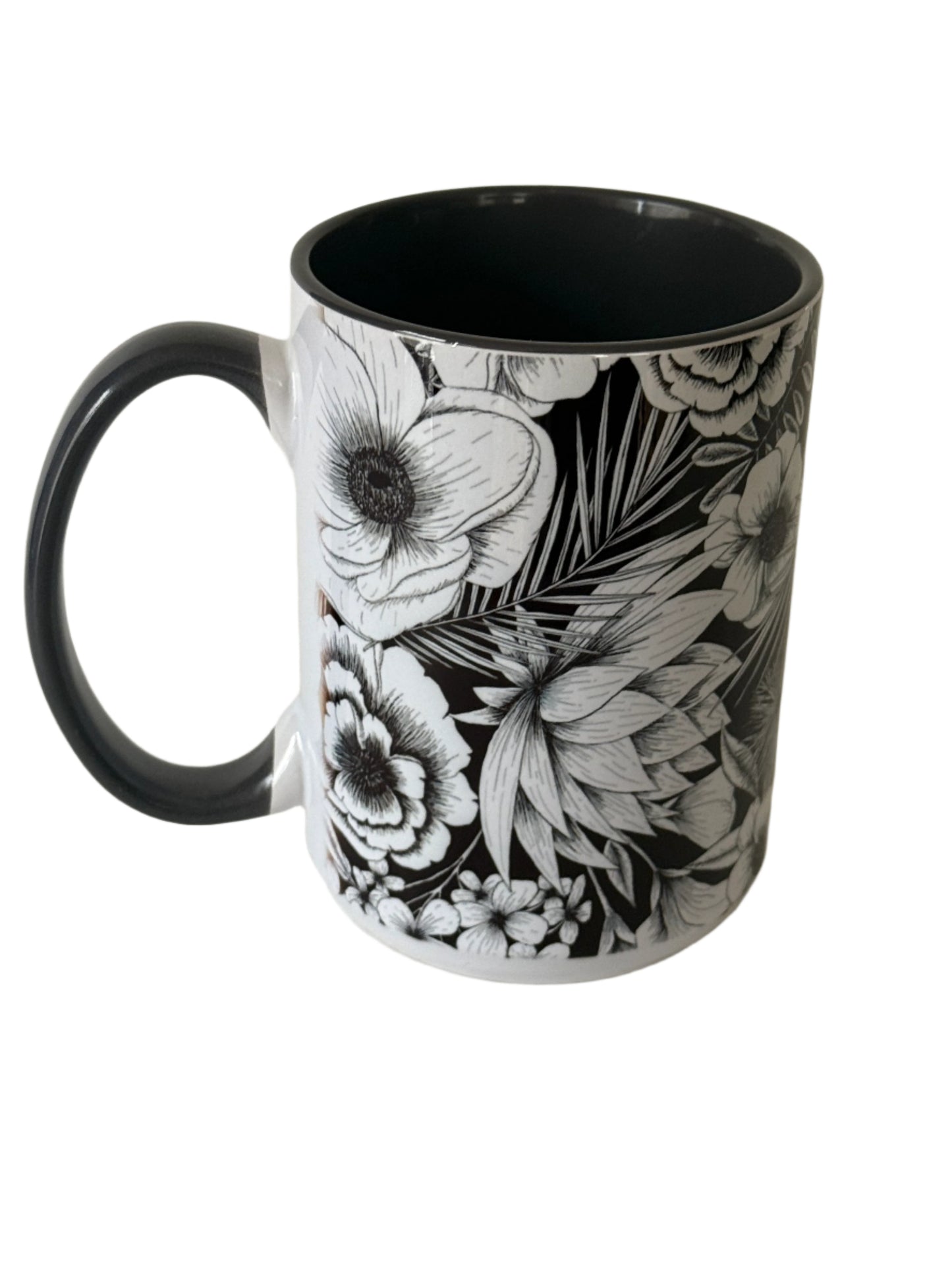 Beautiful 15 oz mug with black and white botanical flower. Mug has a gray interior and gray handle.