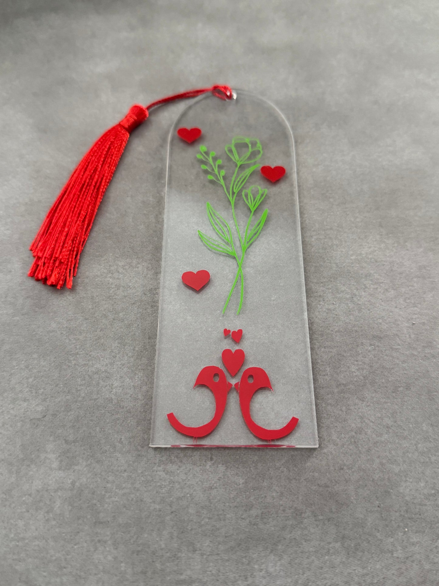 Acrylic bookmark with green flowers, red love birds, and a red tassel Roxzell