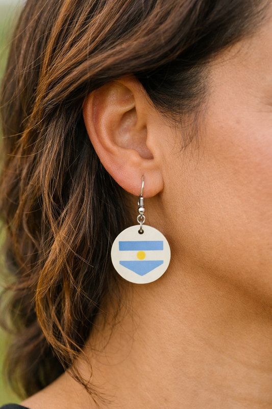 Argentina flag earring with a blue and white design worn by a person. Roxzell