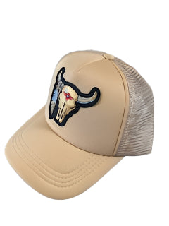 Beige cap with a bull head and feather patch on a white background.