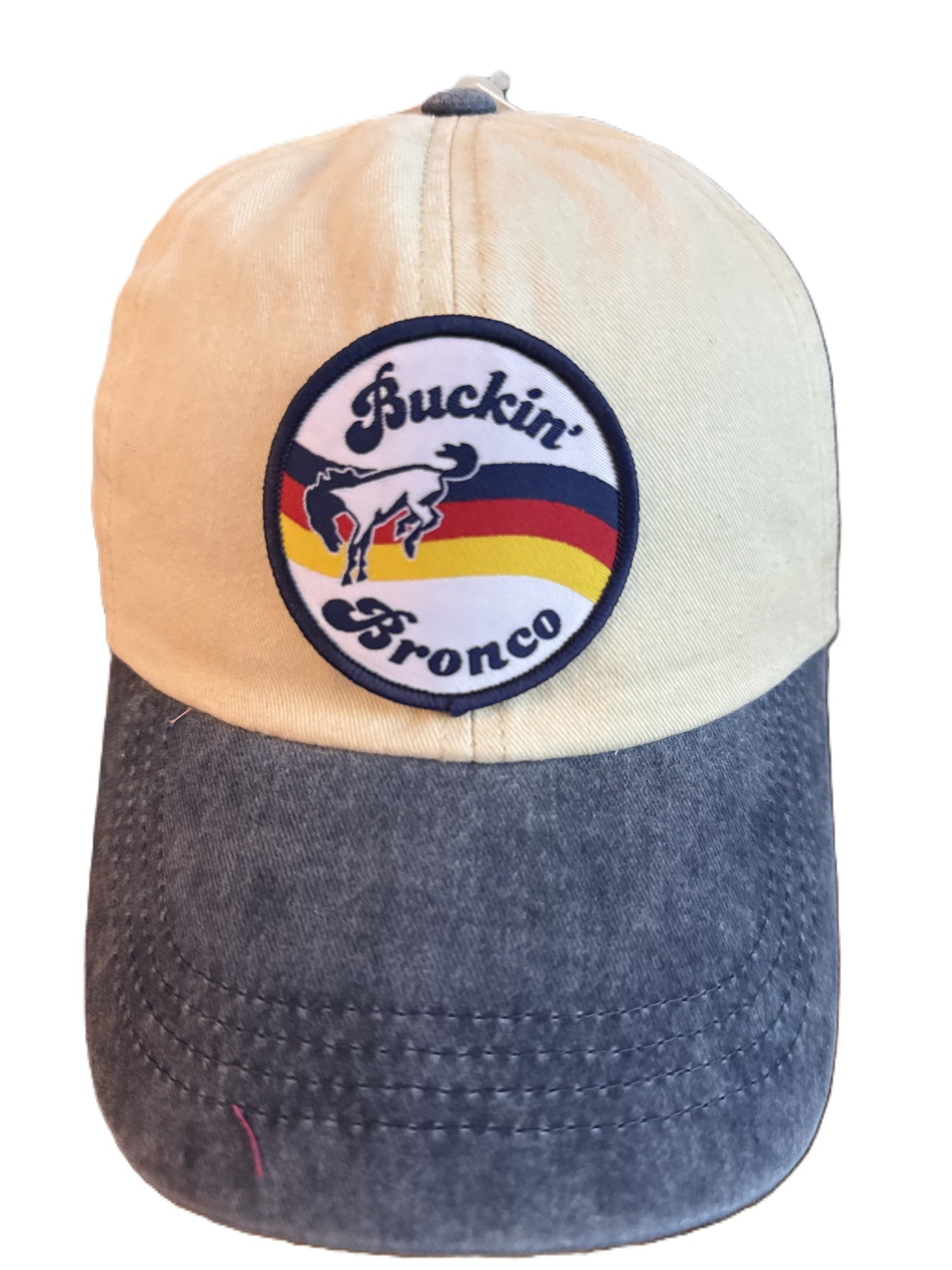 Close-up front view of the same “Buckin’ Bronco” cap, showing the embroidered patch with a horse and multicolor stripes in greater detail. Roxzell