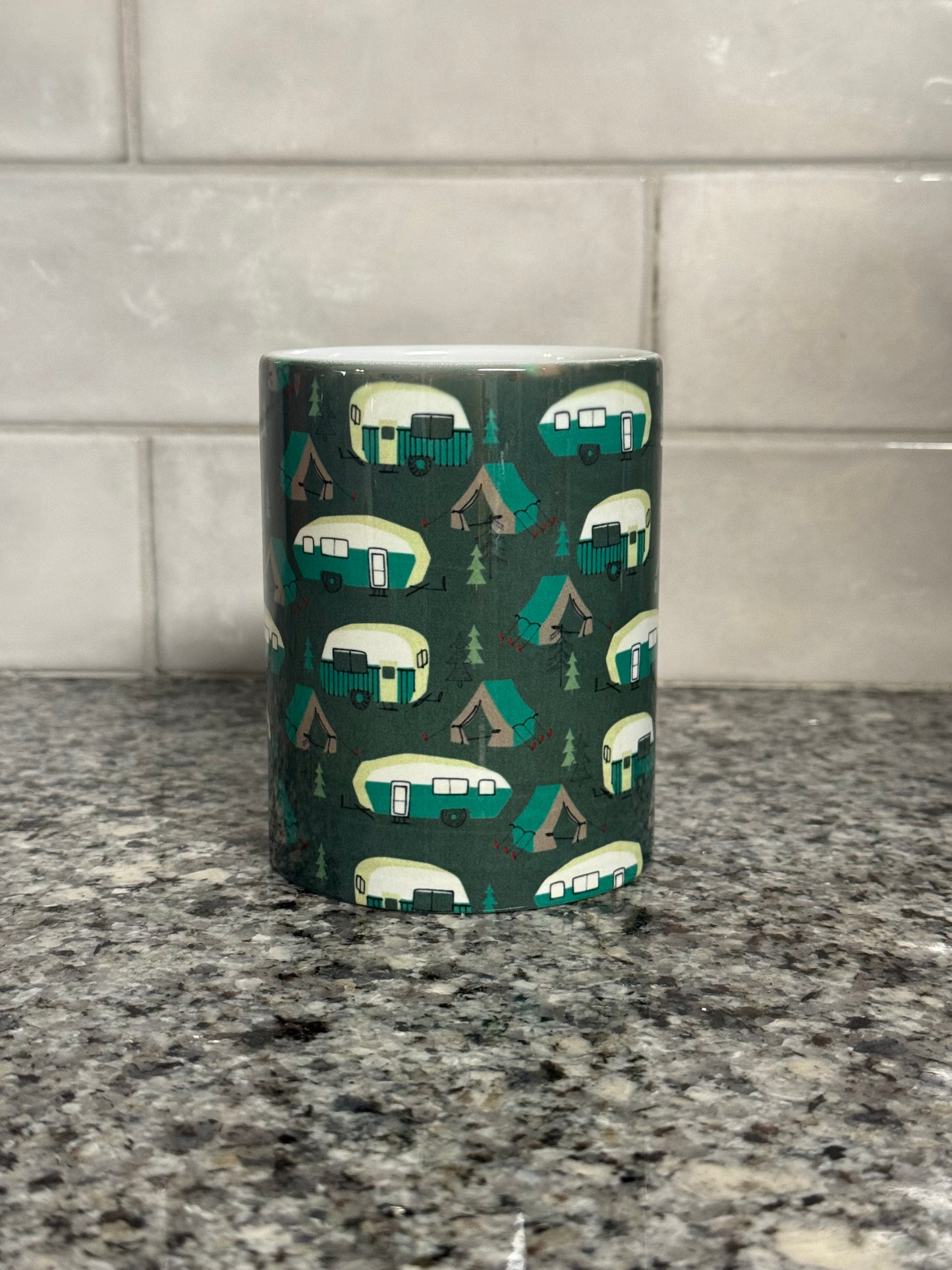 12 oz mug designed with green and white campers, trees, and tents. Part of our camper series.