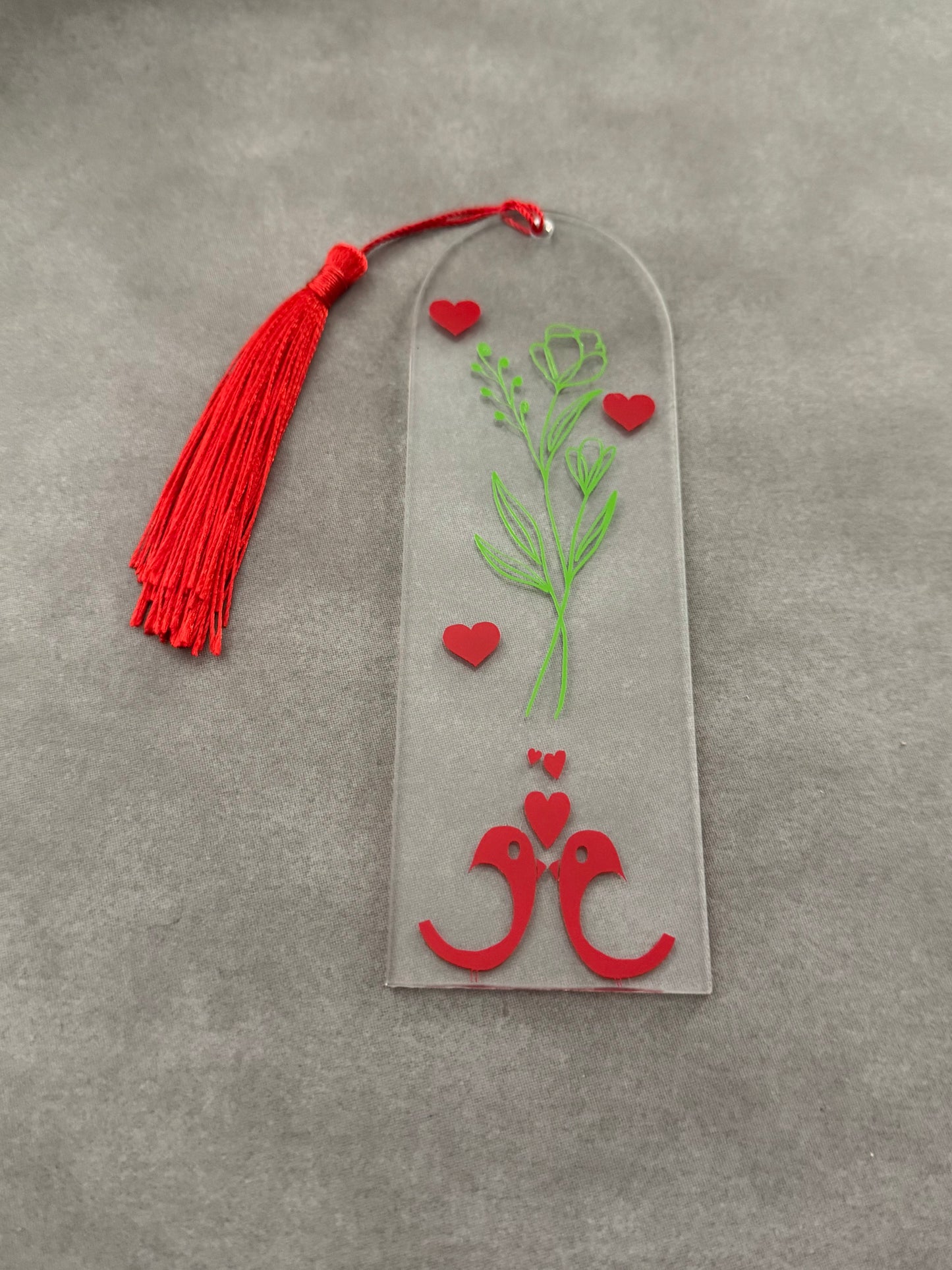 Acrylic bookmark with green flowers, red love birds, and a green tassel Roxzell
