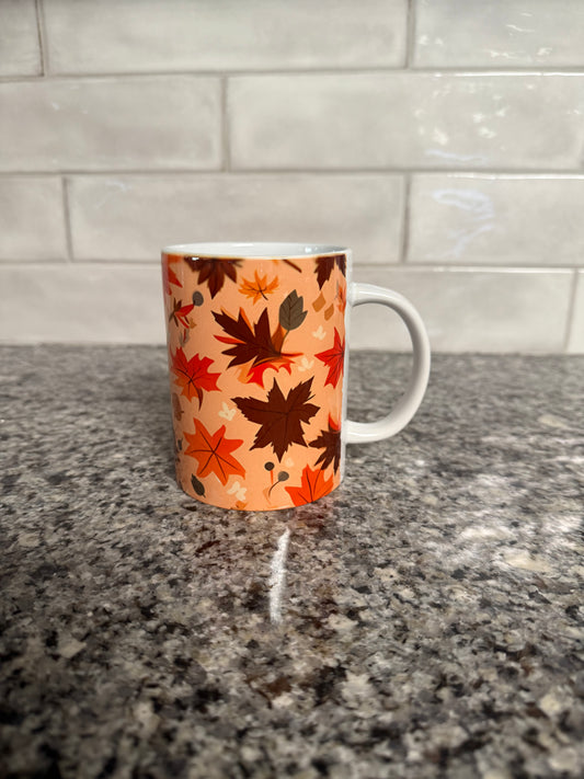 Mug with orange and brown autumn leaf pattern, right side, Roxzell