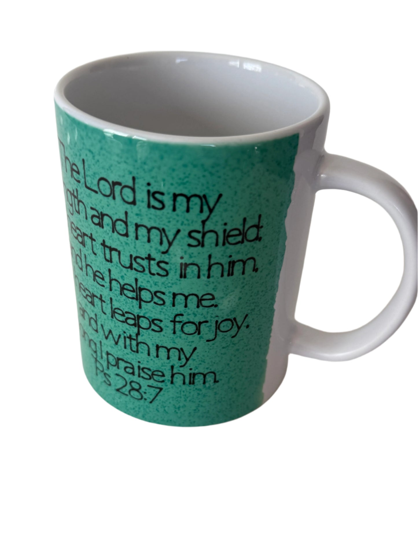 A green ceramic coffee/tea mug with the word 'JOY' written on it, displayed with white background.