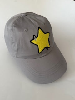 Gray baseball cap with a yellow star patch trimmed in black. Adjustable back strap.