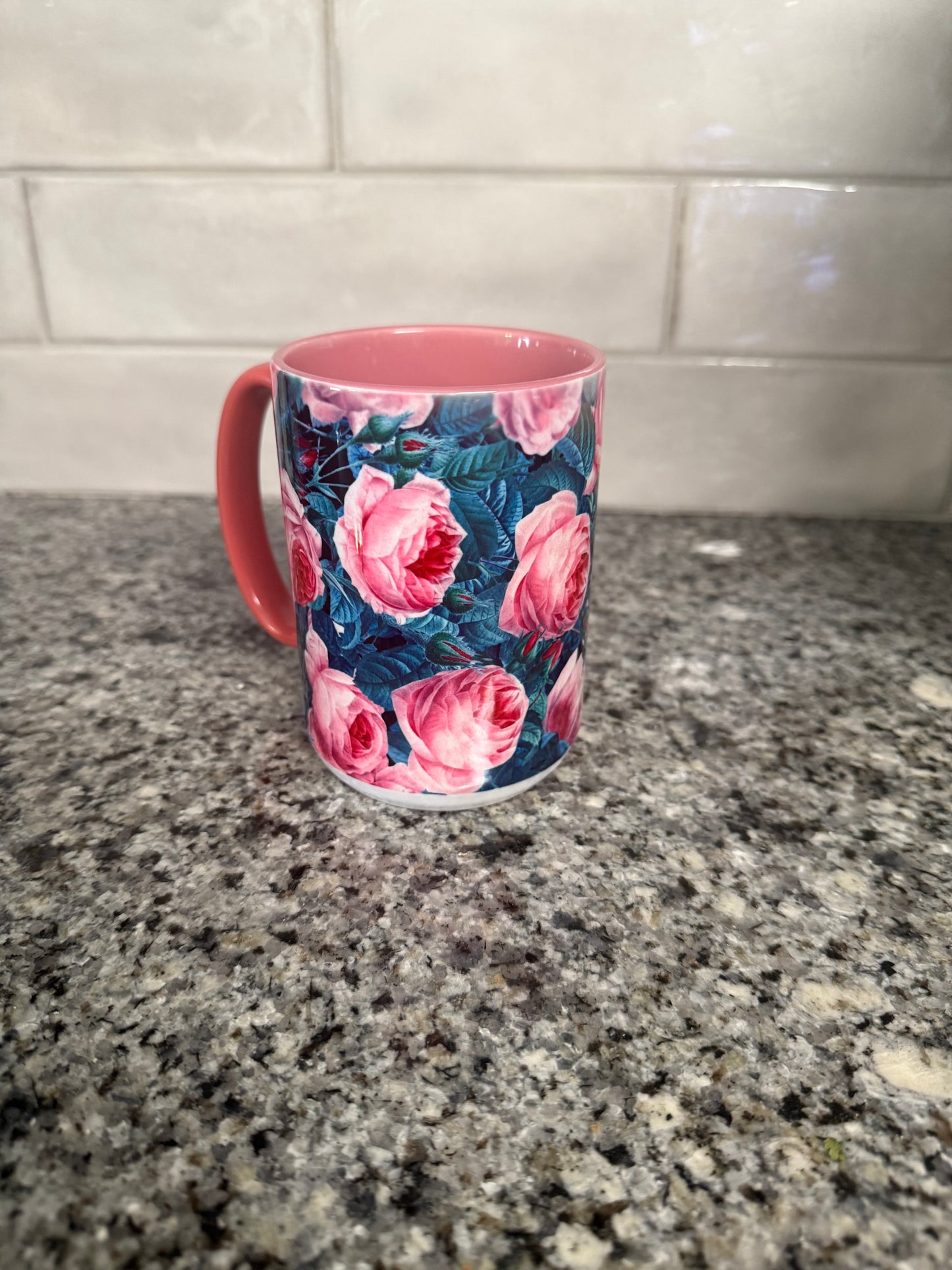 15 oz ceramic mug designed with pink and blue roses and pink handle. Mug is also pink inside.