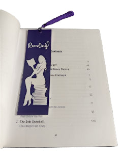 Book with a bookmark featuring a silhouette of a person reading a book, on a textured surface.