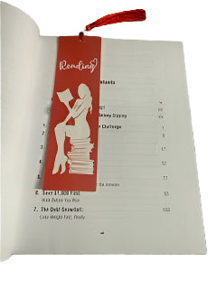 Book with a red bookmark on a textured surface