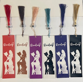Set of colorful bookmarks with silhouettes of a woman reading on white background