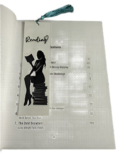 Book with a bookmark featuring a silhouette of a person reading, on a textured surface.