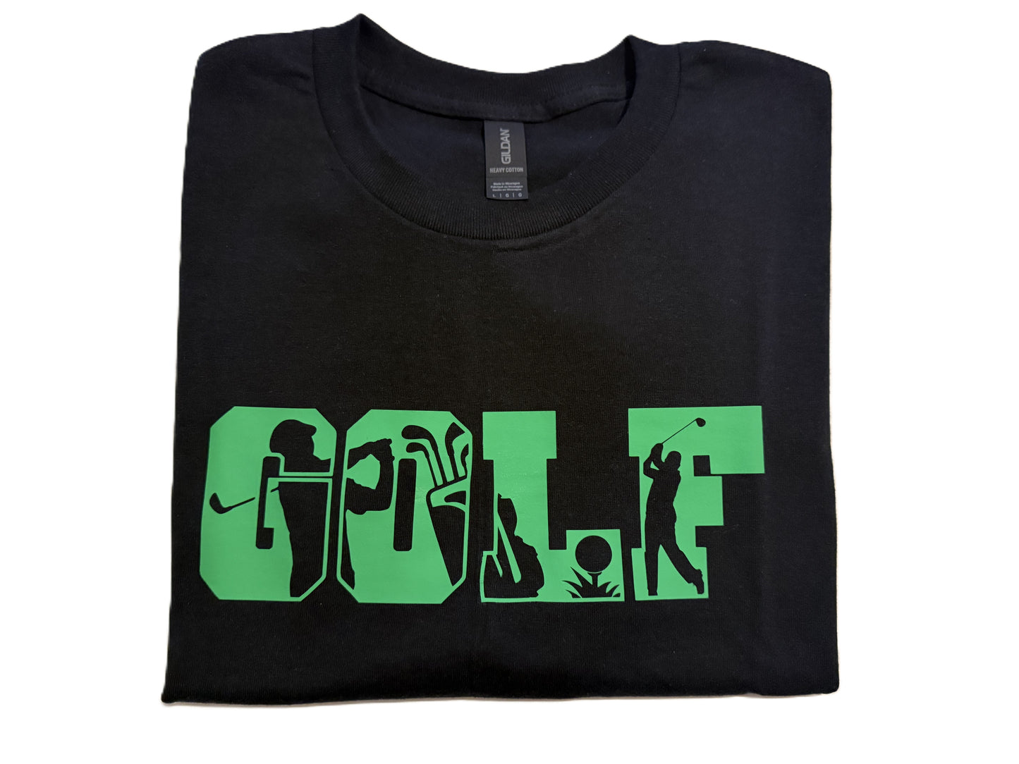 Folded black golf t‑shirt showing green golf‑themed design, Roxzell