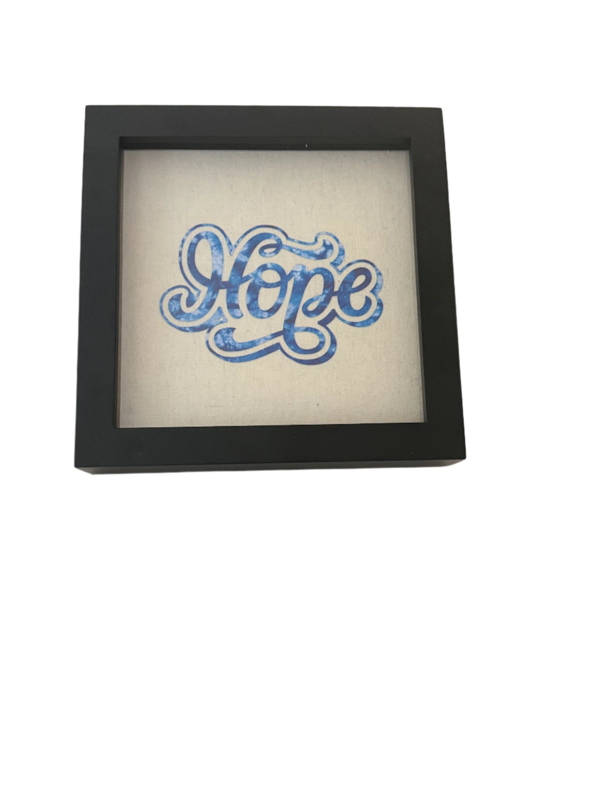 8 x 8 Black frame shadow box designed with the work "Hope" in blue on tan canvas.