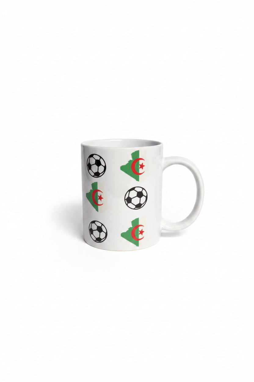 Ceramic mug decorated with Algeria’s crescent‑star symbol and black‑and‑white soccer balls on a white background.