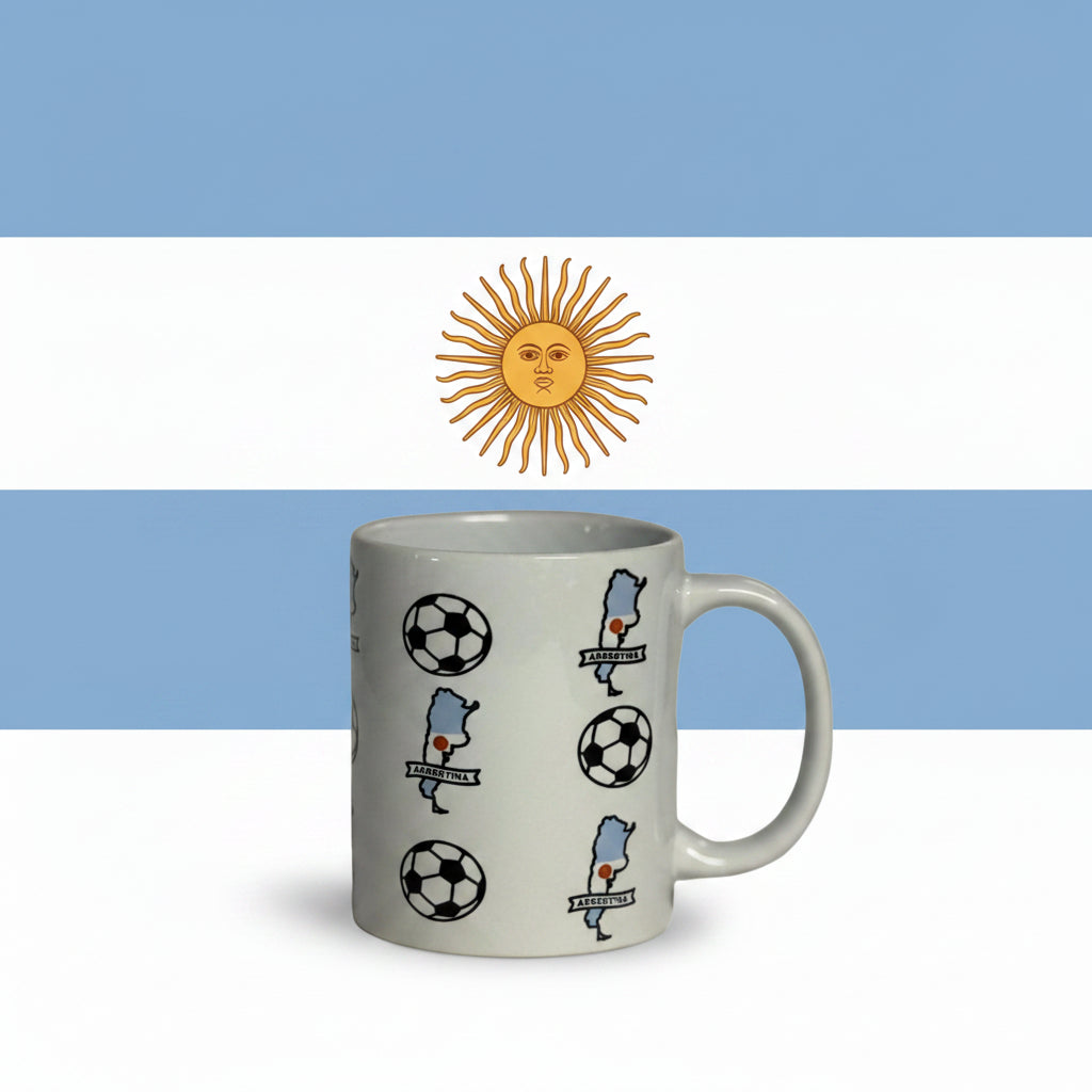 White ceramic mug featuring Argentina map and soccer ball pattern, displayed in front of the Argentine flag with light blue and white stripes and the golden Sun of May emblem.