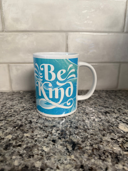 "Be Kind' ceramic coffee mug in blue and green with white handle Roxzell