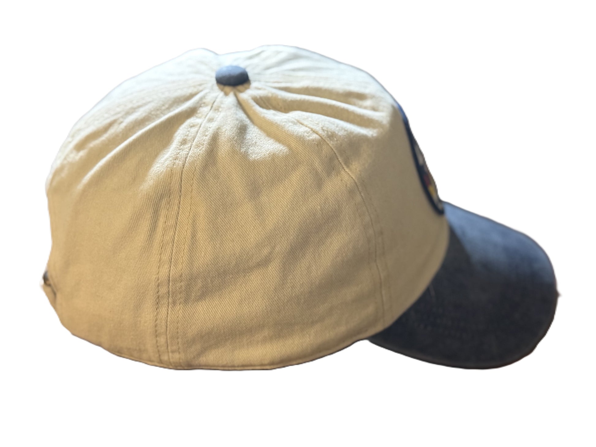 Right side view of a beige and denim-blue baseball cap featuring a circular patch with a bucking horse and the text “Buckin’ Bronco” over red, yellow, and blue stripes. Roxzell