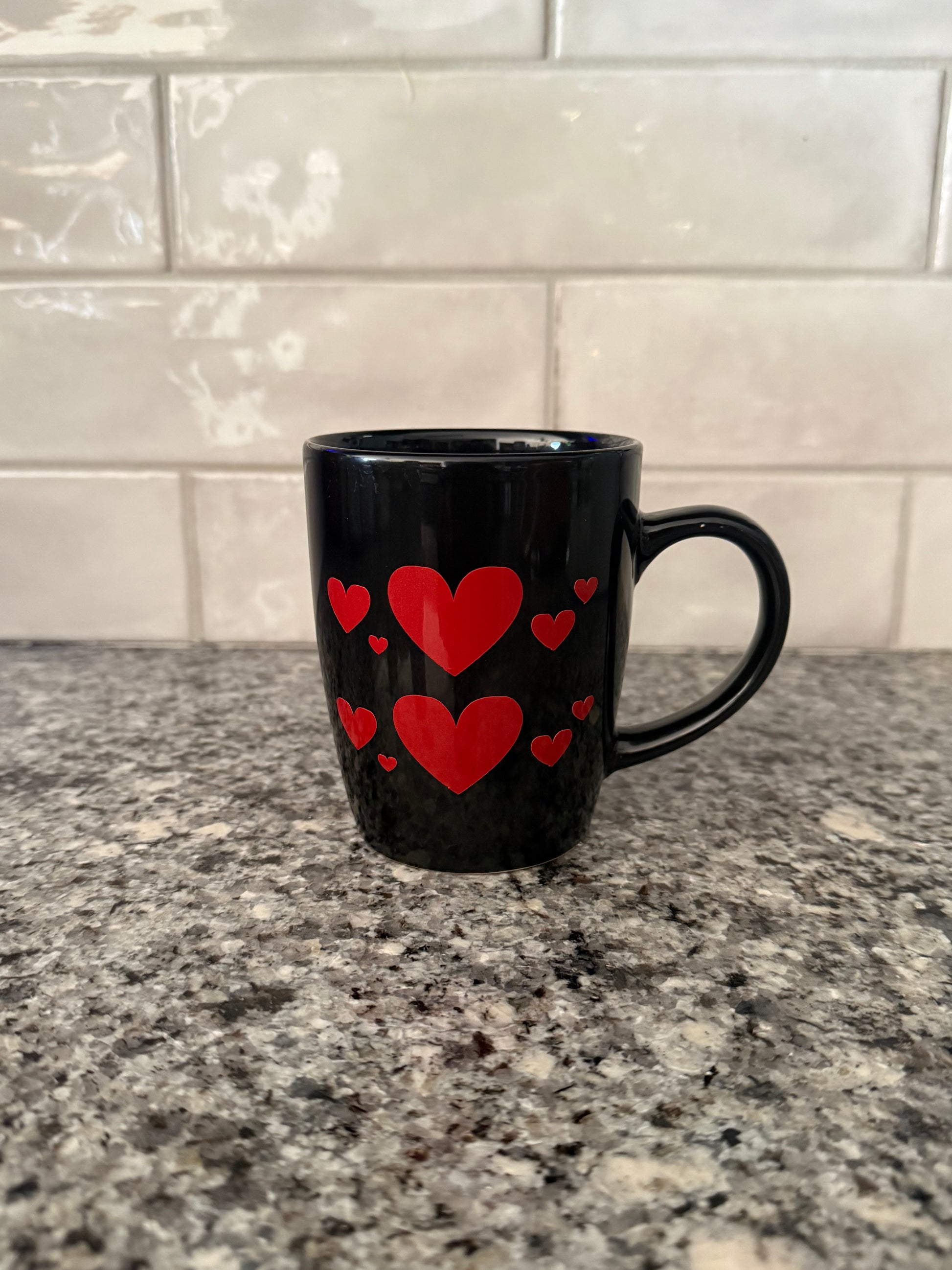 Valentine’s Day mug featuring red heart design on one side and "Love" on the other side on a granite countertop, Roxzell