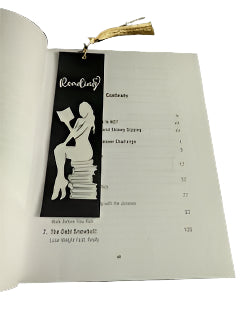 Book with a bookmark featuring a silhouette of a woman and text on a textured surface