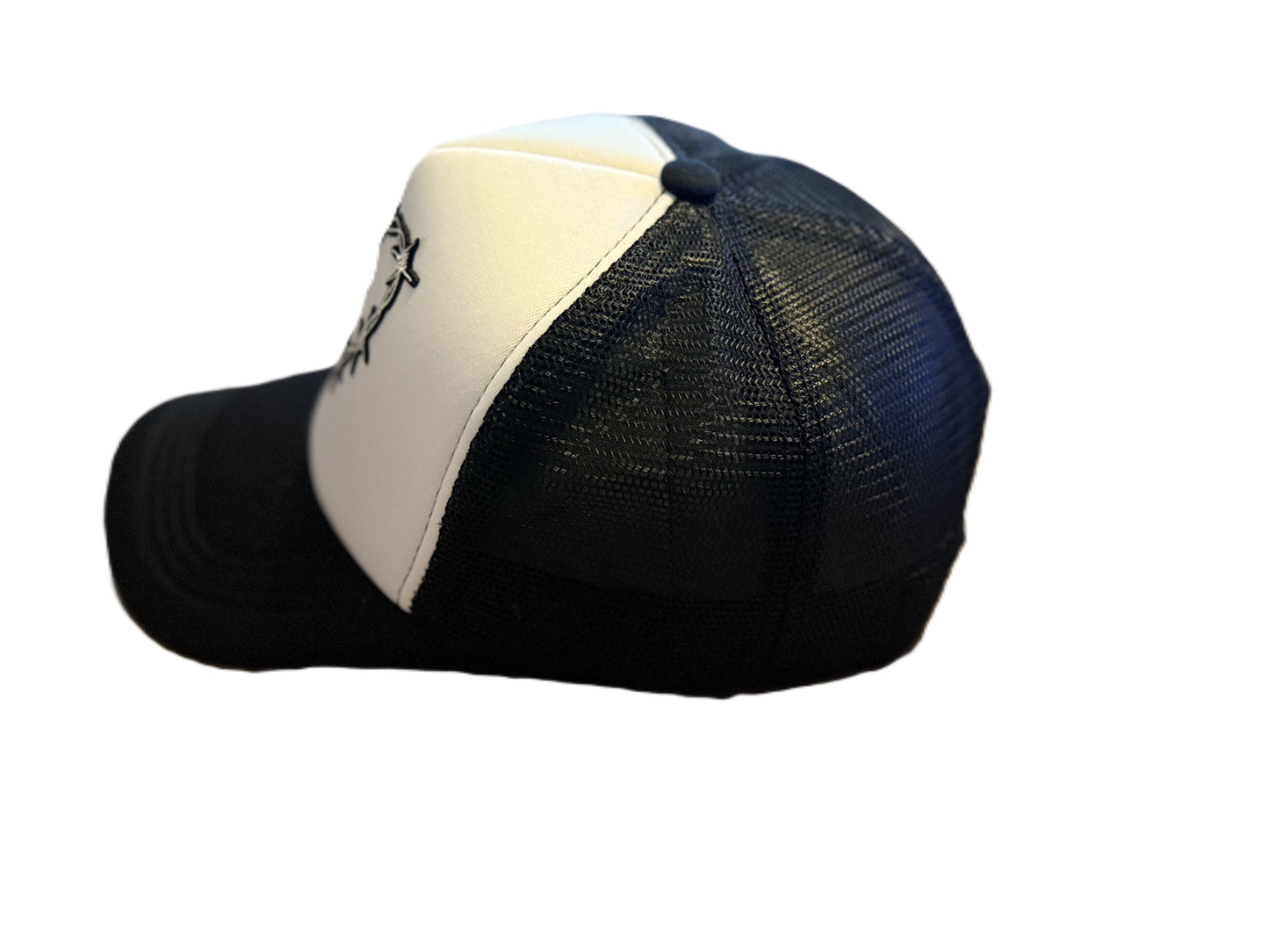 Left side view of barbed-wire heart trucker cap showing the white front panel and the breathable black mesh sides and brim. Roxzell