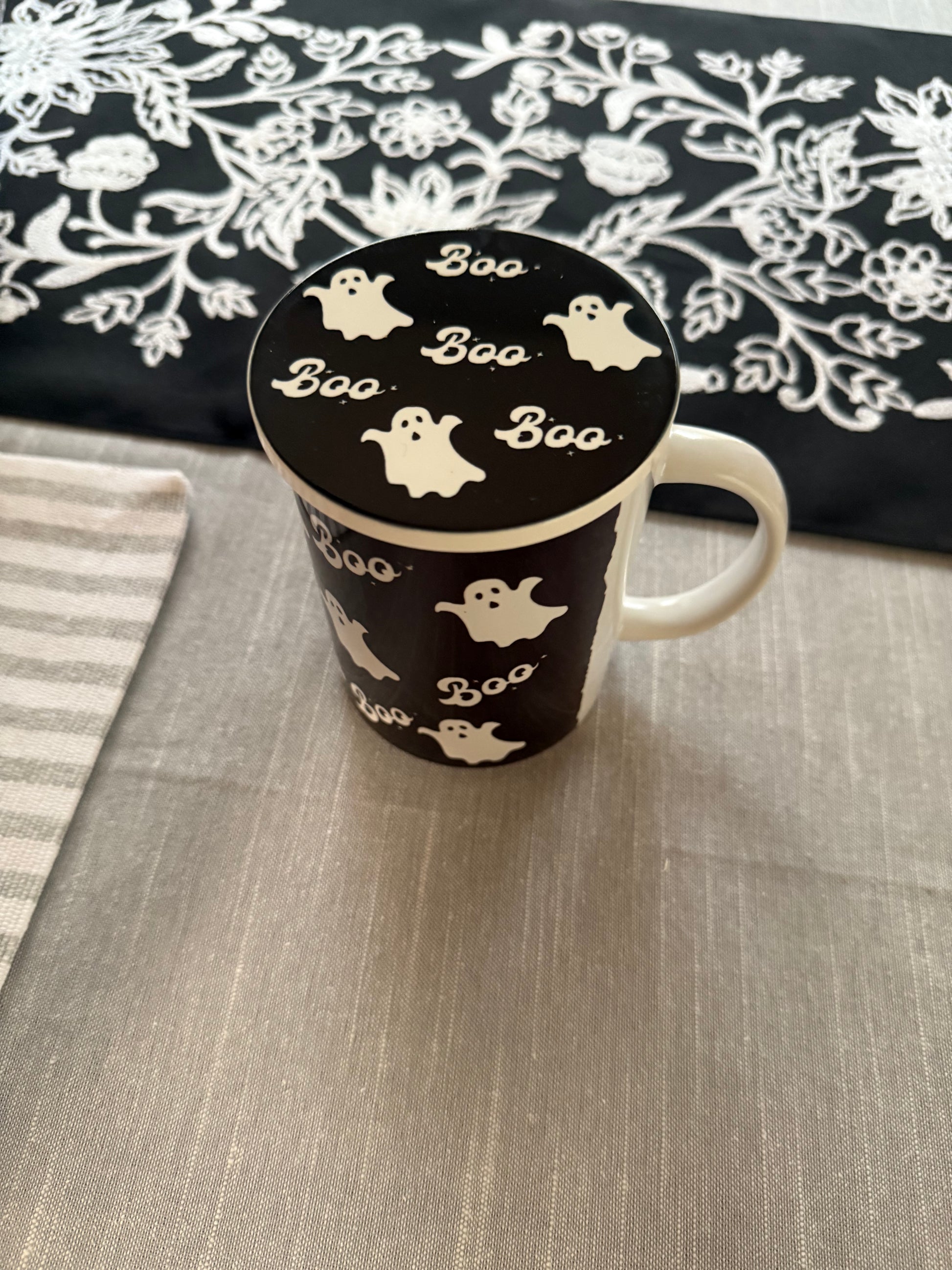 Black and white Halloween mug with Ghost and "Boo" text  design with matching coaster used to cover to of mug, Roxzell