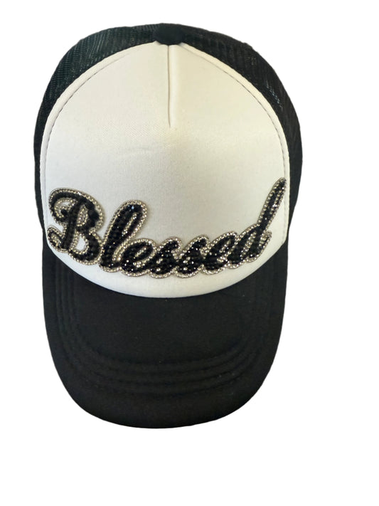Black and white baseball cap with bejeweled "Blessed" design on the front.  