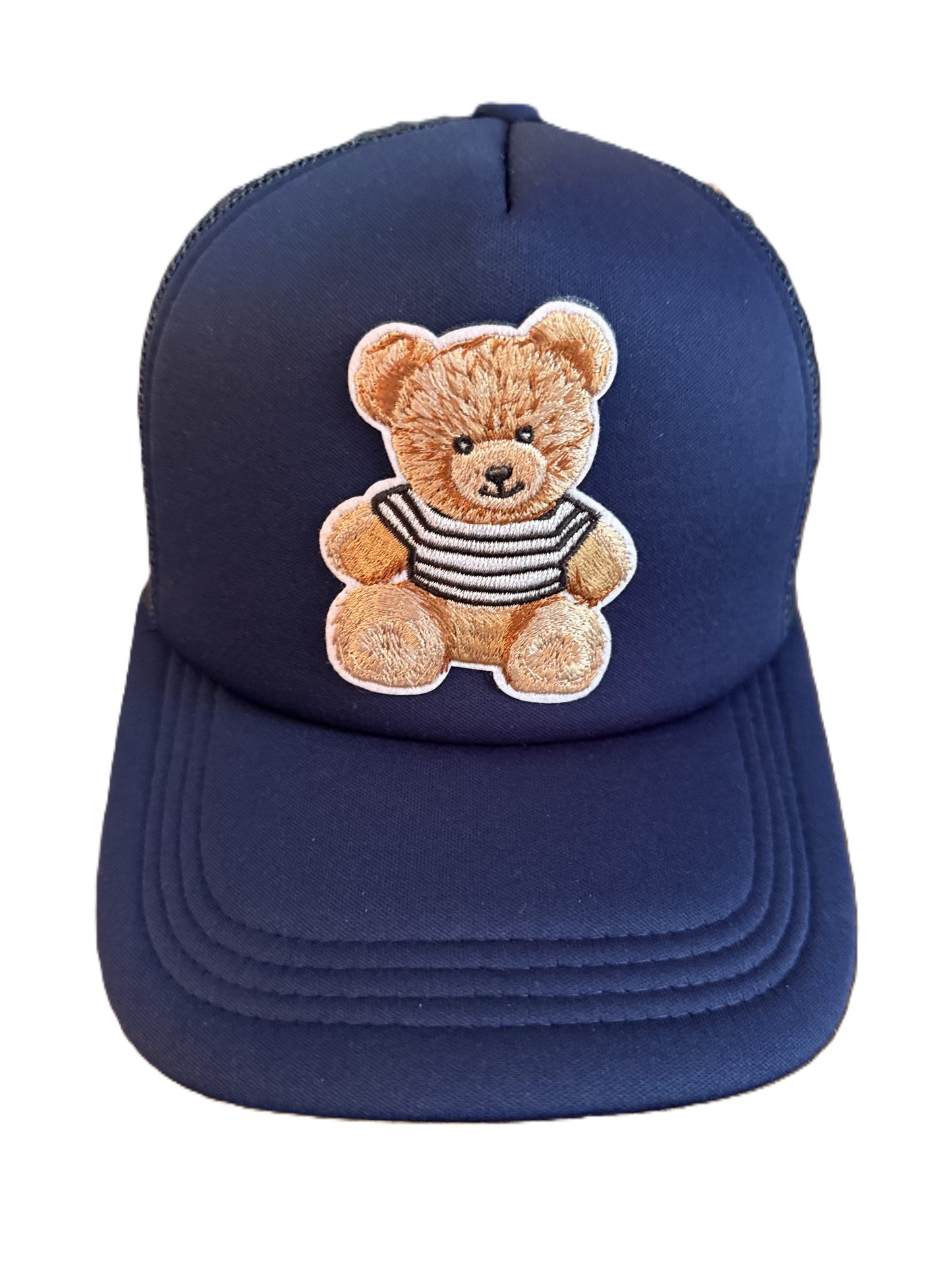 Dark blue baseball cap featuring an embroidered teddy bear wearing a striped shirt on the front panel. Roxzell