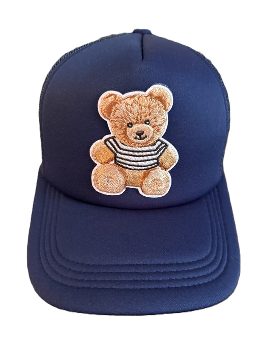 Dark blue baseball cap featuring an embroidered teddy bear wearing a striped shirt on the front panel. Roxzell