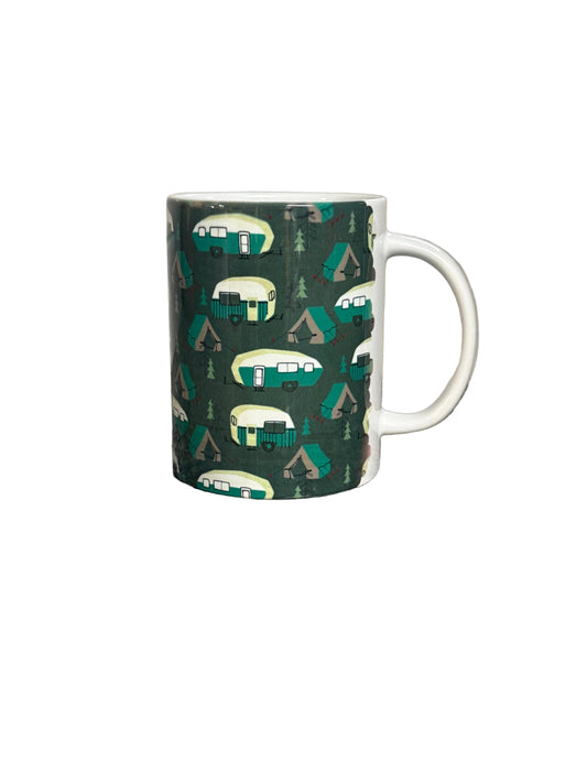 A white ceramic mug featuring a dark green camping-themed pattern with retro campers, tents, and pine trees, shown against a plain white background. Roxzell