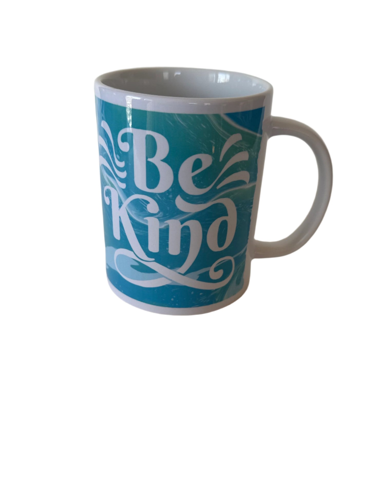 Right side view of "Be Kind' ceramic coffee mug in blue and green with white handle Roxzell