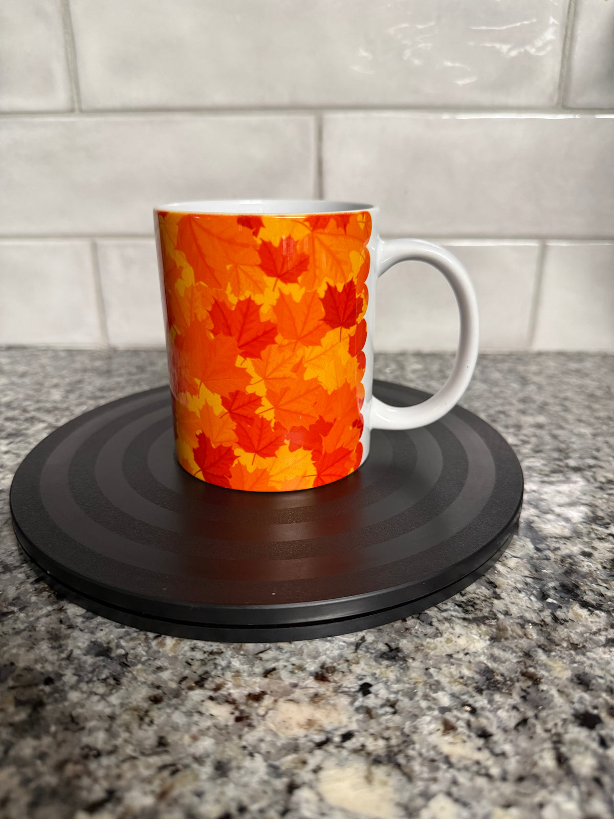 12oz ceramic mug with all-over autumn leaves print in amber, orange and gold tones. Roxzell