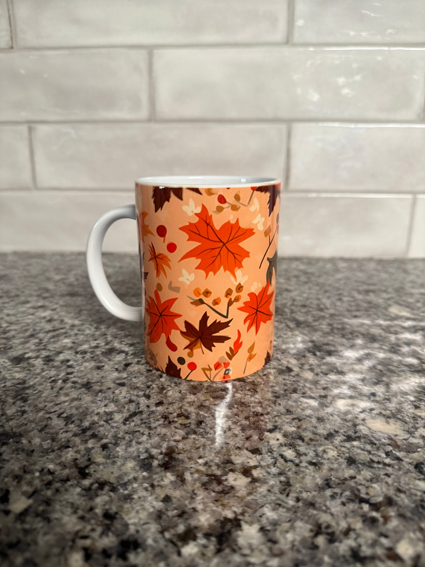 Mug with orange and brown autumn leaf pattern, left side, Roxzell