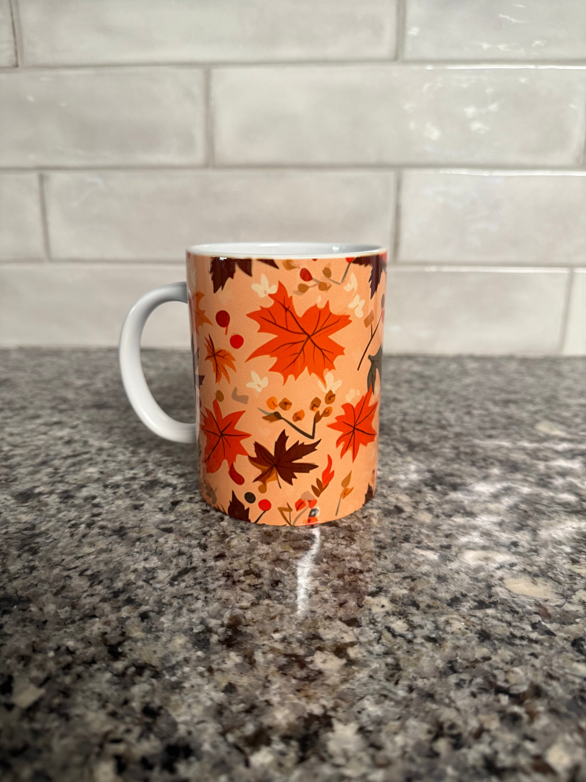 Mug with orange and brown autumn leaf pattern, left side, Roxzell