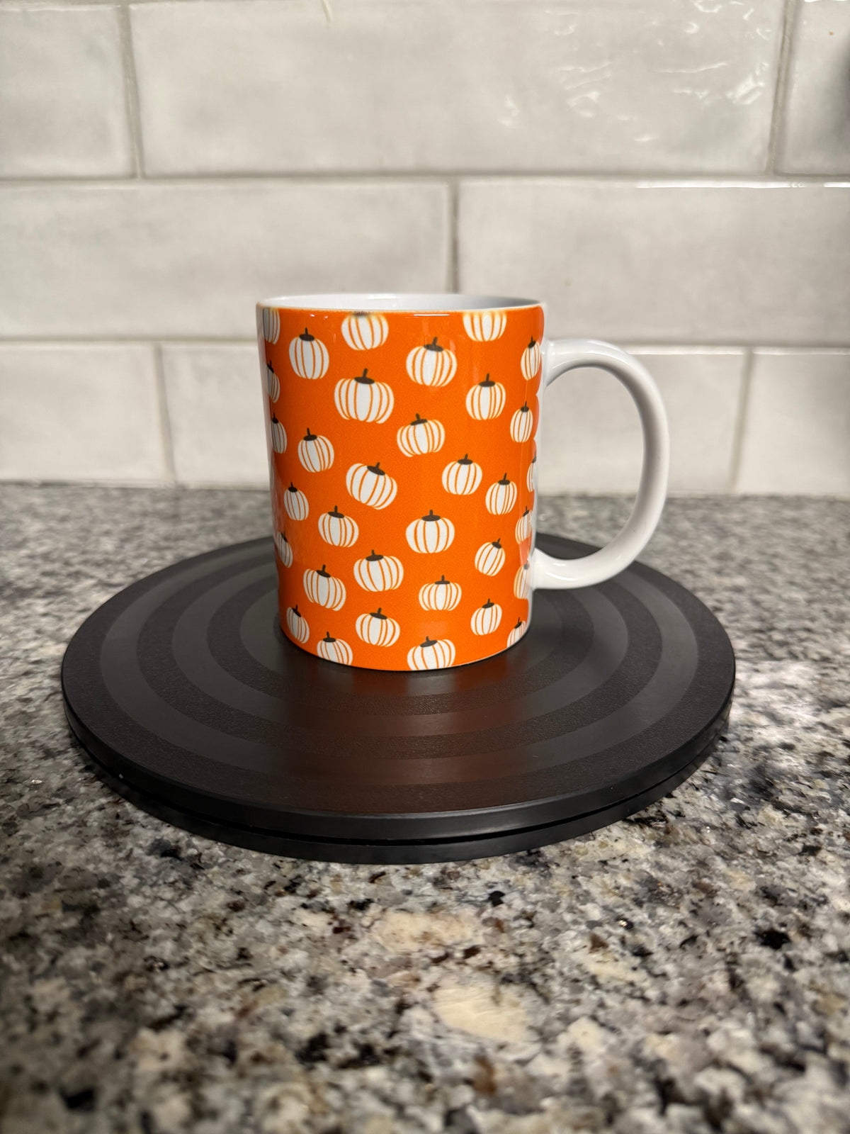 12oz ceramic mug with white pumpkin pattern on orange background