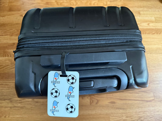 White luggage tag with alternating soccer balls and blue Argentina map outlines. Roxzell