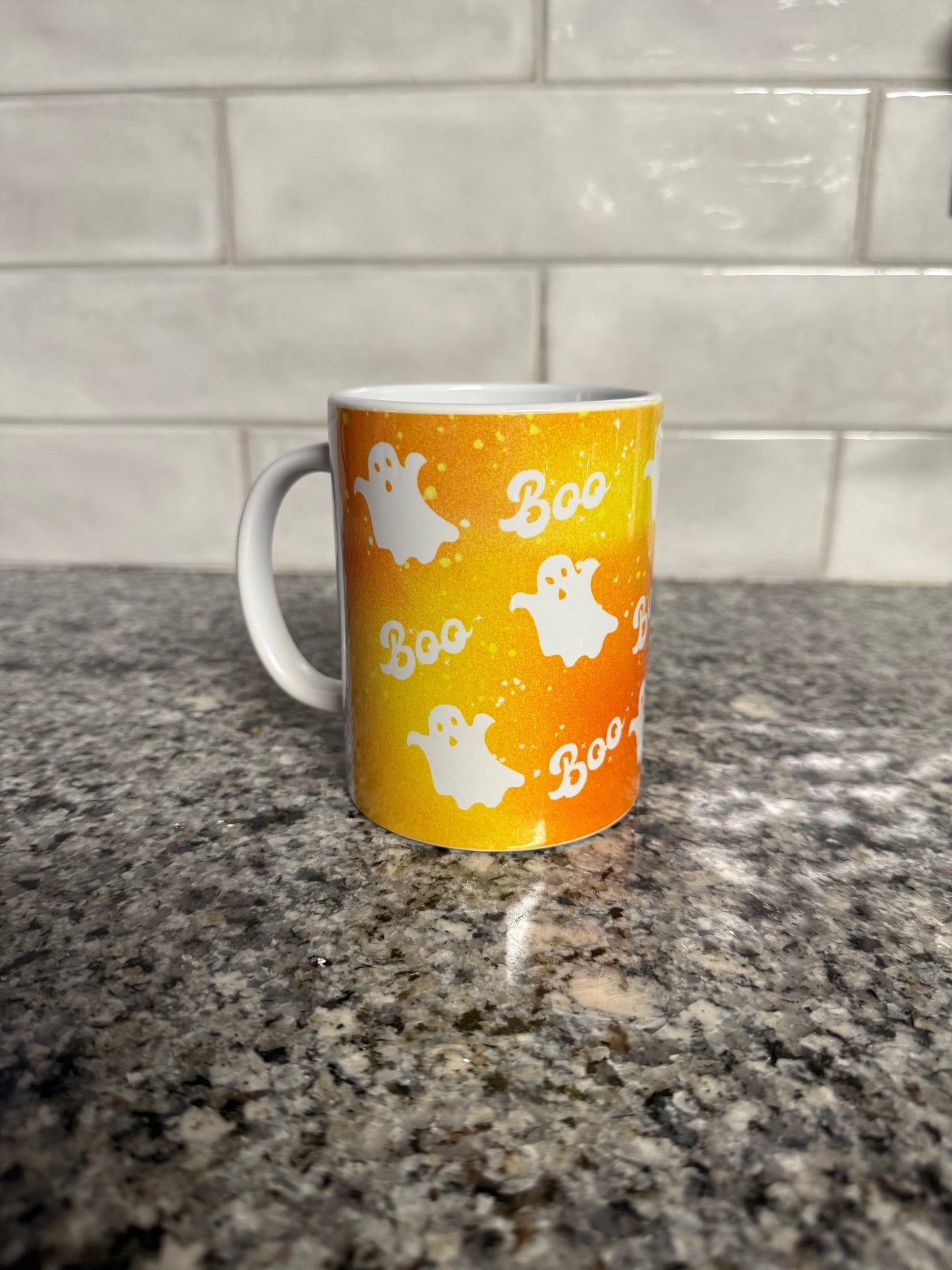 Orange and white Halloween mug with ghosts and the word "Boo" in the design, Roxzell