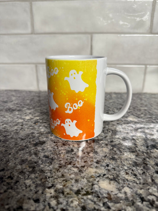 Orange and white Halloween mug with ghosts and the word "Boo" in the design, Roxzell
