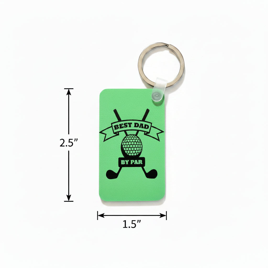 Green keychain with black design featuring crossed golf clubs, a golf ball, and the phrase “Best Dad by Par” printed in bold lettering. Roxzell