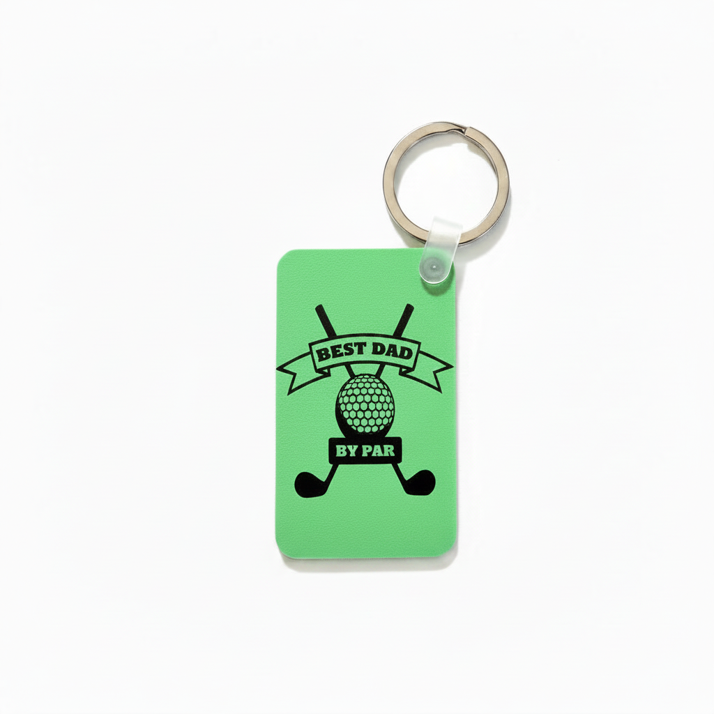 Green keychain with black design featuring crossed golf clubs, a golf ball, and the phrase “Best Dad by Par” printed in bold lettering. 2.5" dimension shown on the left side and 1.5" dimension arrow shown below keychain. Roxzell