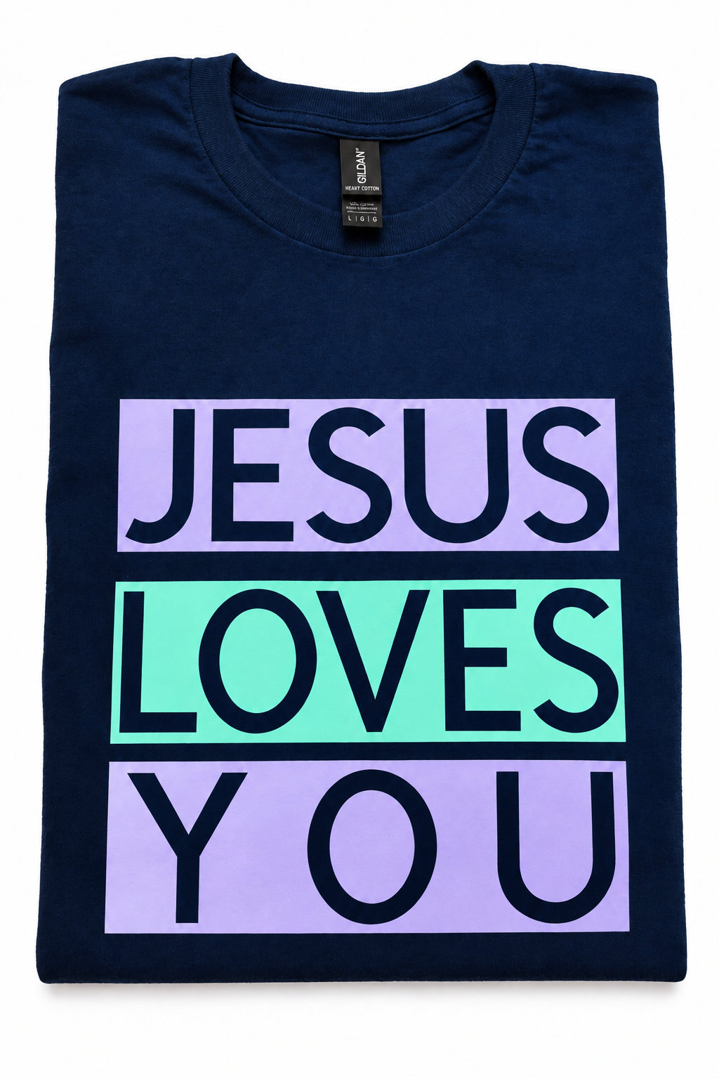 A folded navy blue t-shirt with a graphic print reading 'JESUS LOVES YOU' in black text across three stacked lavender and mint green blocks, shown on a white background. Roxzell