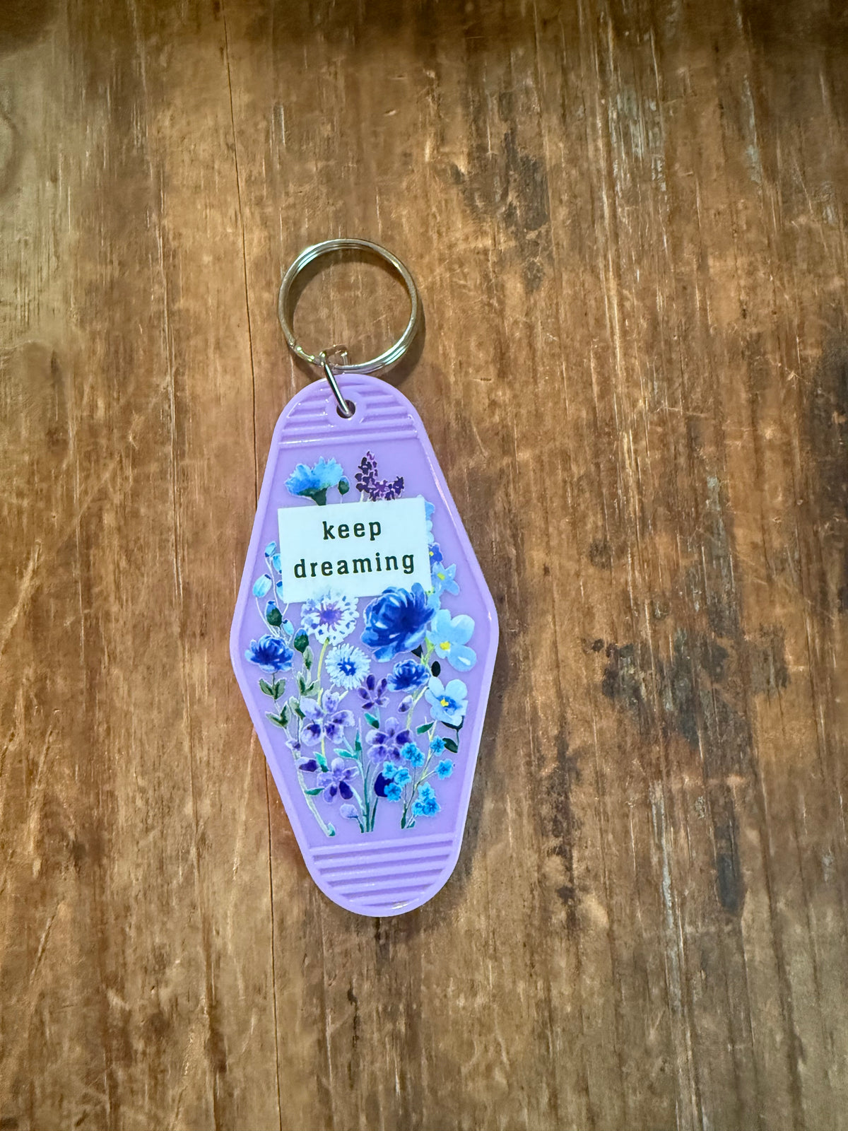 Lilac Keep Dreaming motel-style keychain with blue and purple flowers