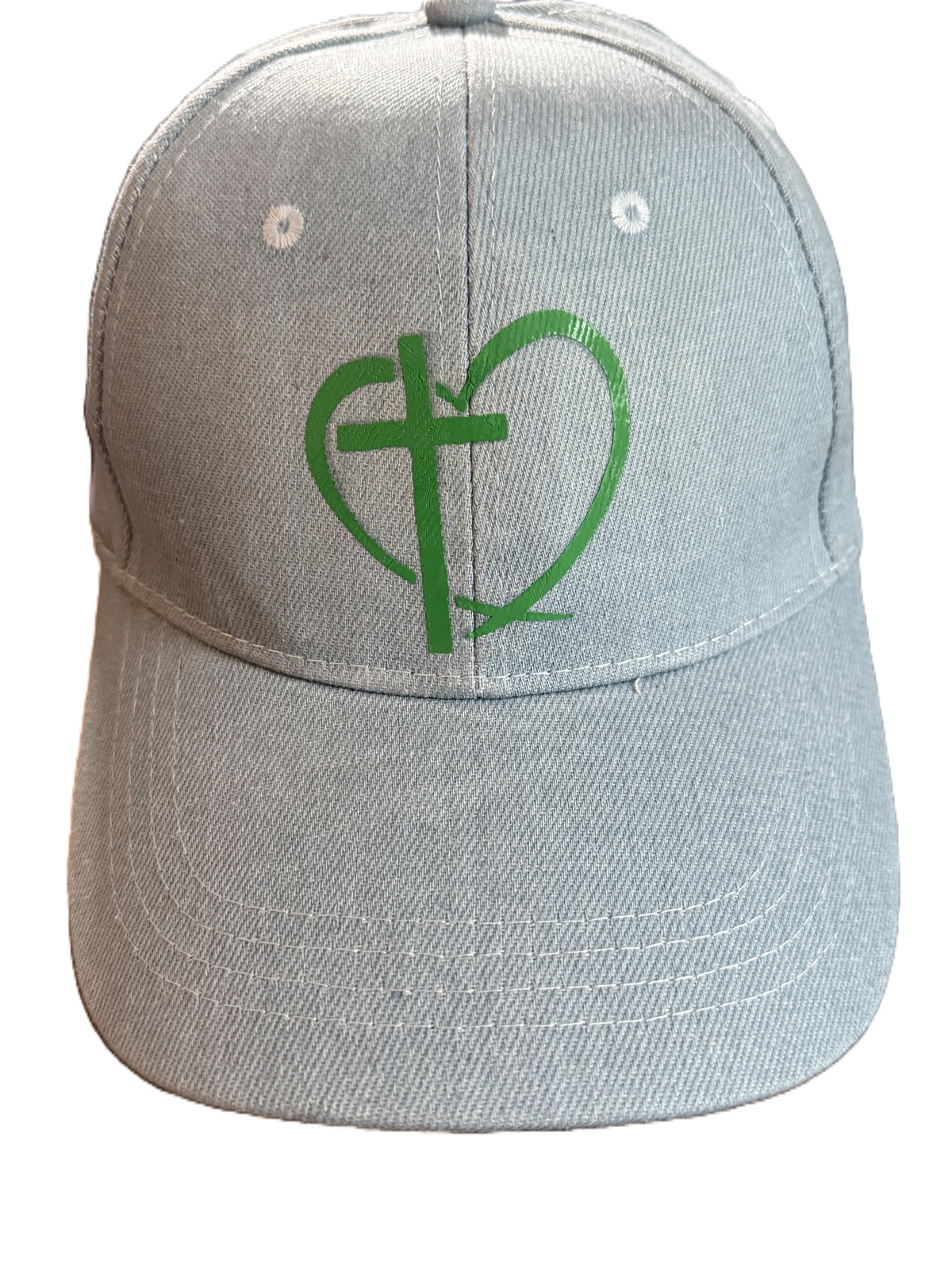 Light blue denim baseball cap with green heart and cross design on front panel. Roxzell