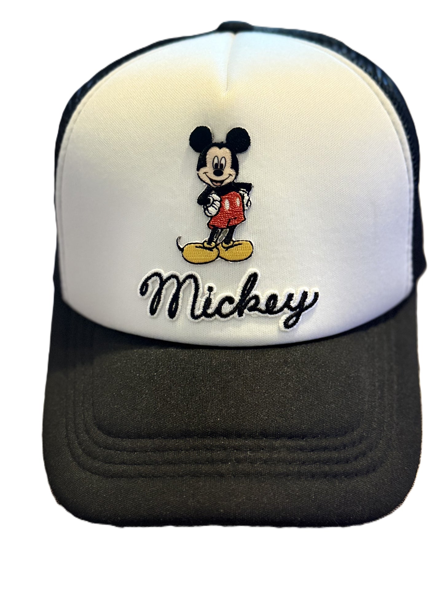 A Mickey Mouse trucker hat with a white front panel, black mesh back, and black brim. The front panel features an embroidered Mickey Mouse graphic above the embroidered black script text 'Mickey'. Roxzell