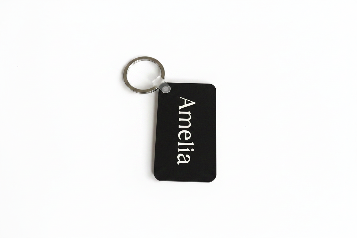 Black personalized Amelia keychain with white name print. Roxzell