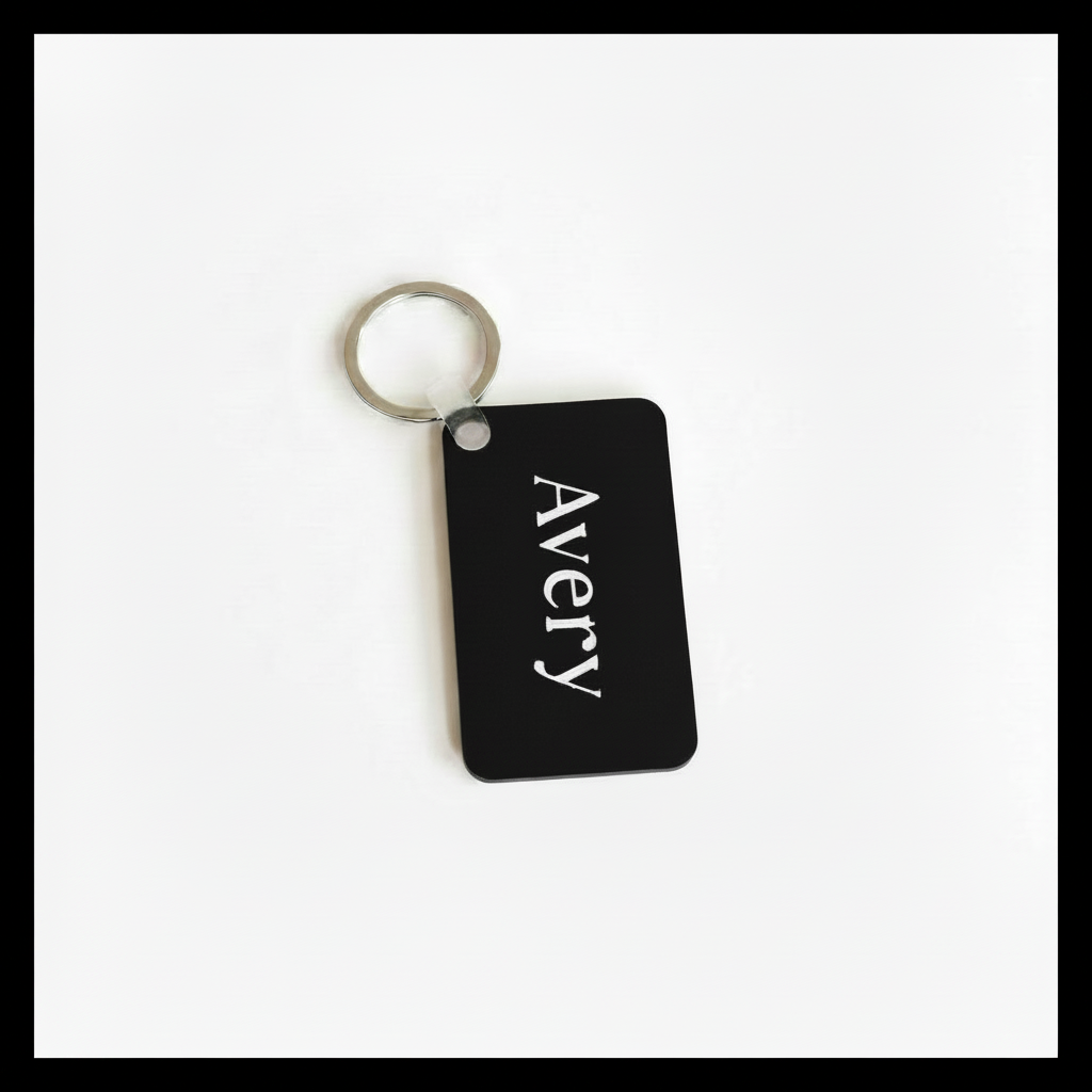 Personalized black keychain with name Avery in white name print on a white background with black border. Roxzell