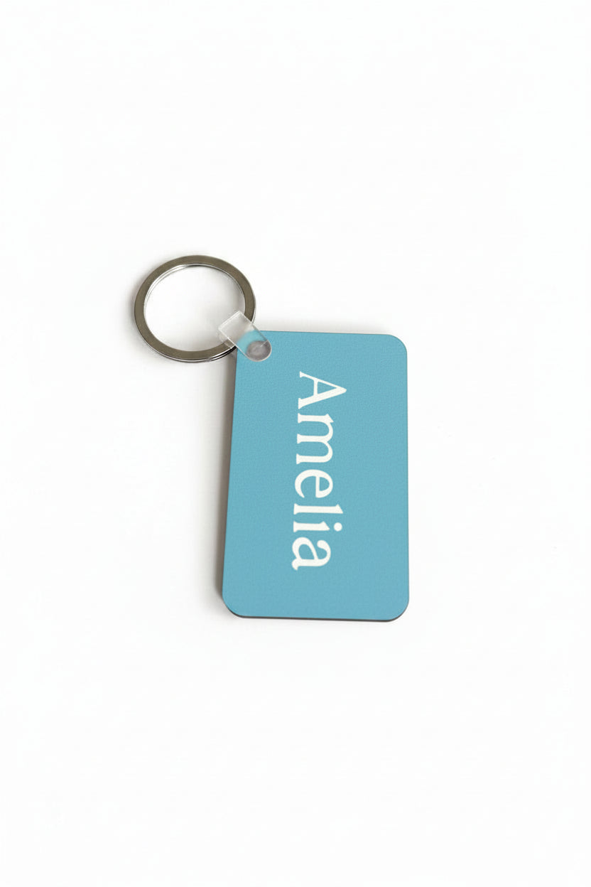 Light blue personalized Amelia keychain with white name print. Roxzell