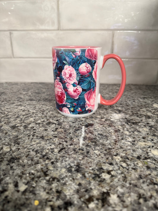 15 oz ceramic mug designed with pink and blue roses and pink handle.  Mug is also pink inside.