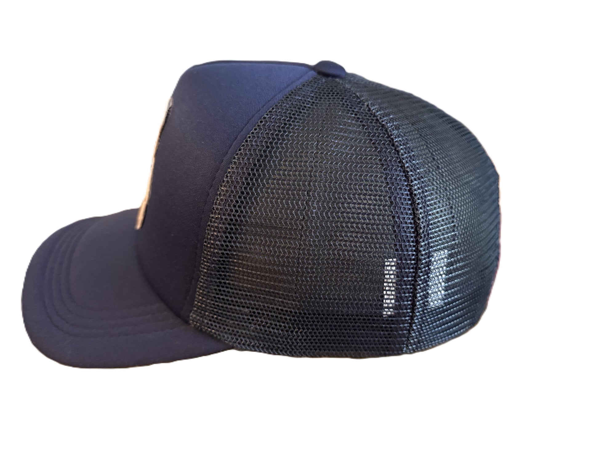 Side view of navy trucker cap showing breathable mesh back and curved brim. Roxzell