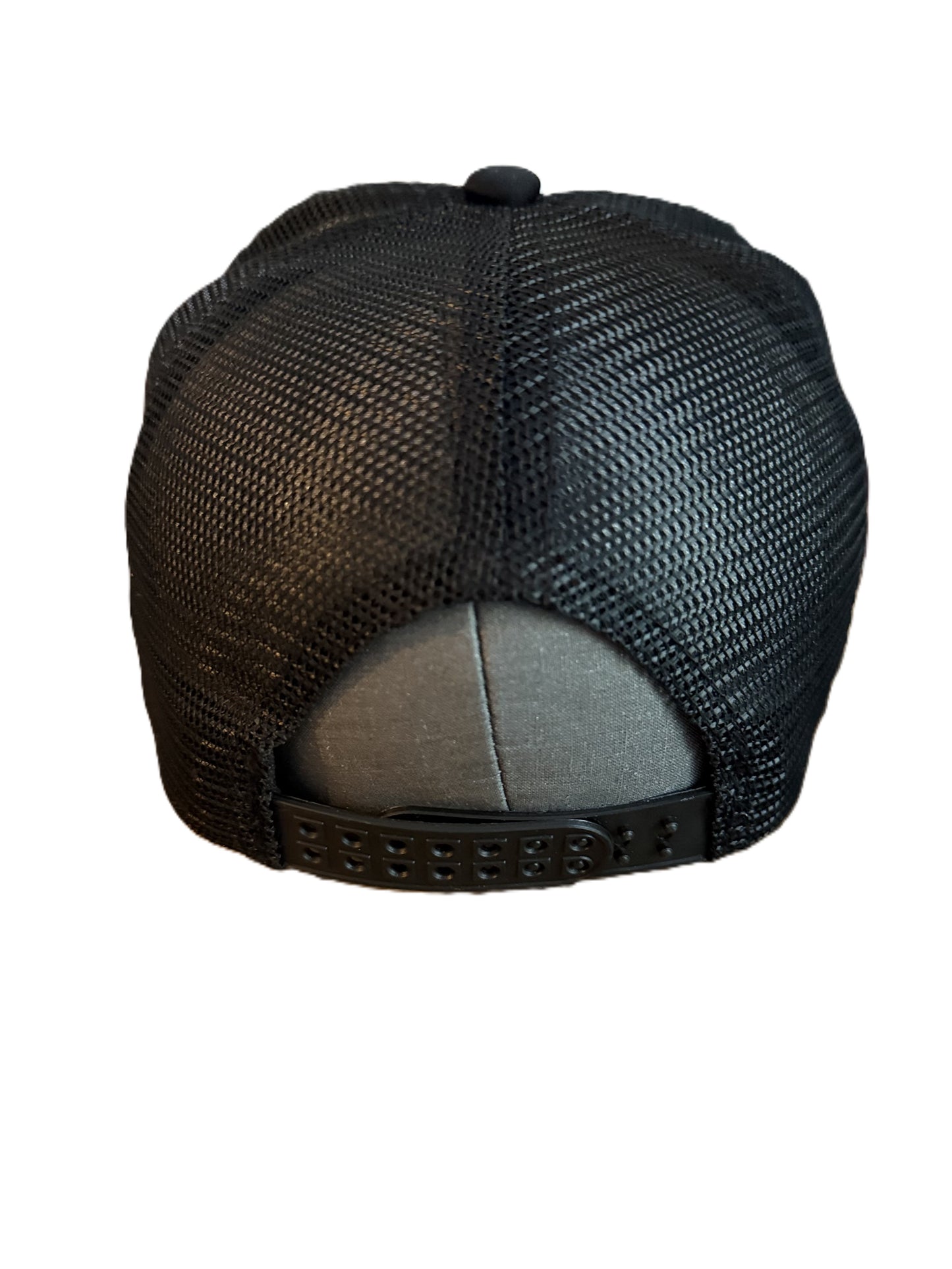 Back view of a black mesh Smiley Face trucker hat showing adjustable snap closure and breathable material. Roxzell