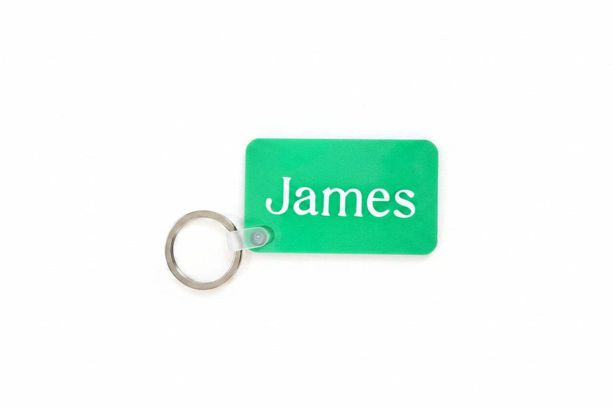 Green personalized keychain with name James' text on a white background. Roxzell